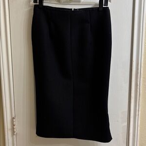 Nina Ricci fully lined black textured pencil skirt with side zipper/slit. NWOT